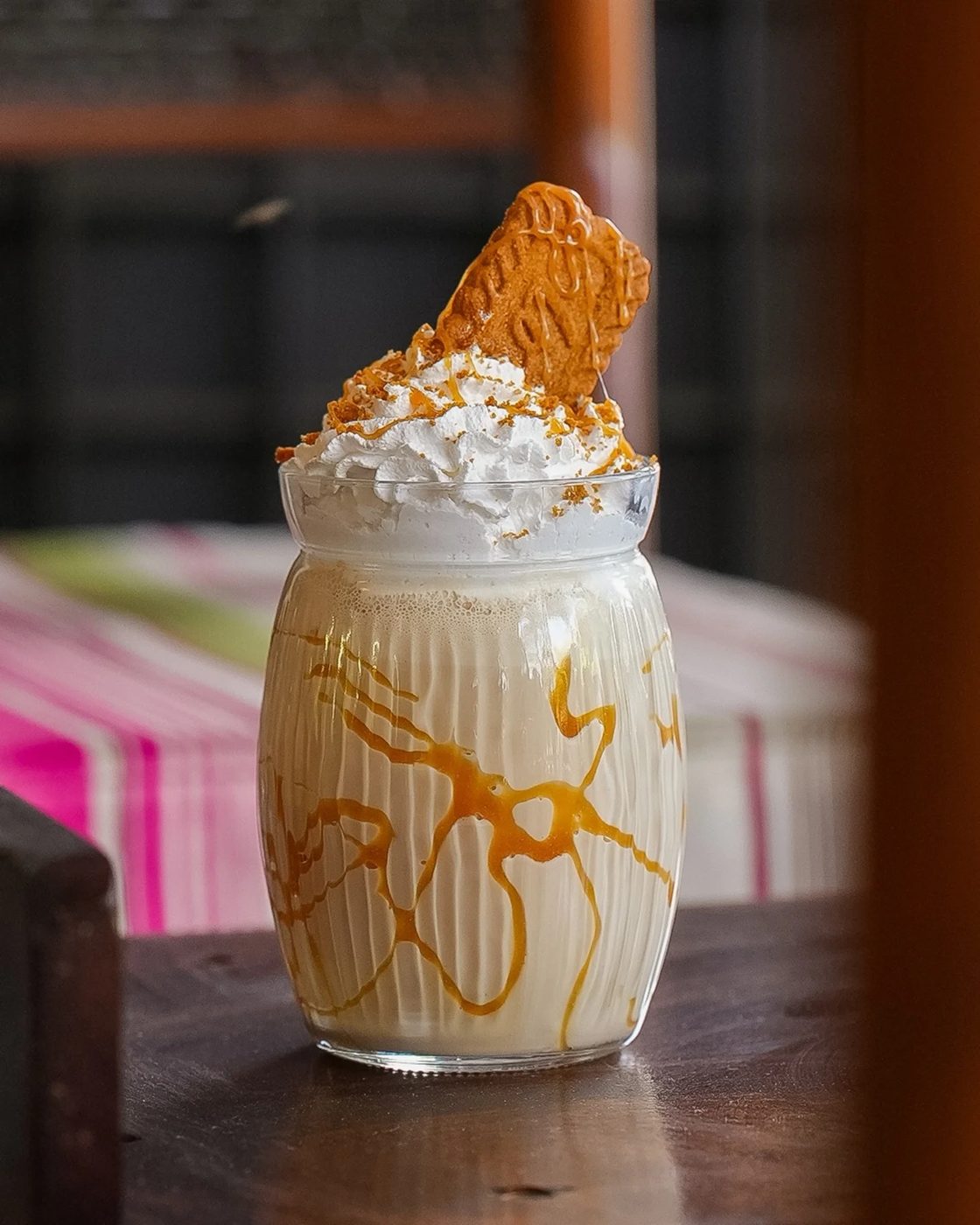 A Biscoff shake in a ribbed jar, caramel-laced, topped with cream