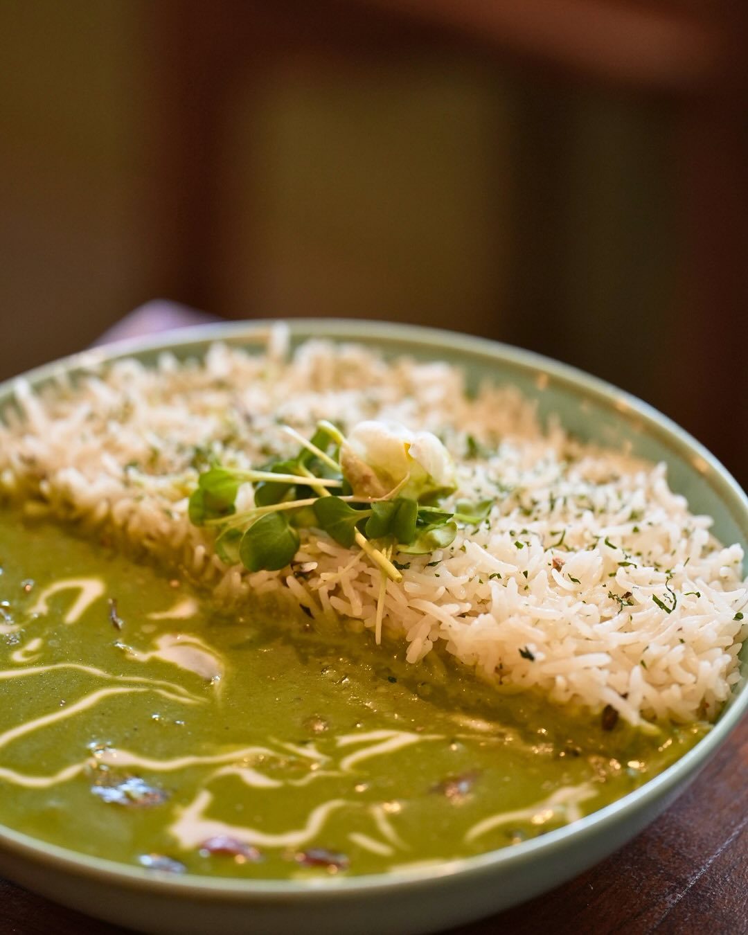 Green Thai curry served alongside steamed jasmine rice
