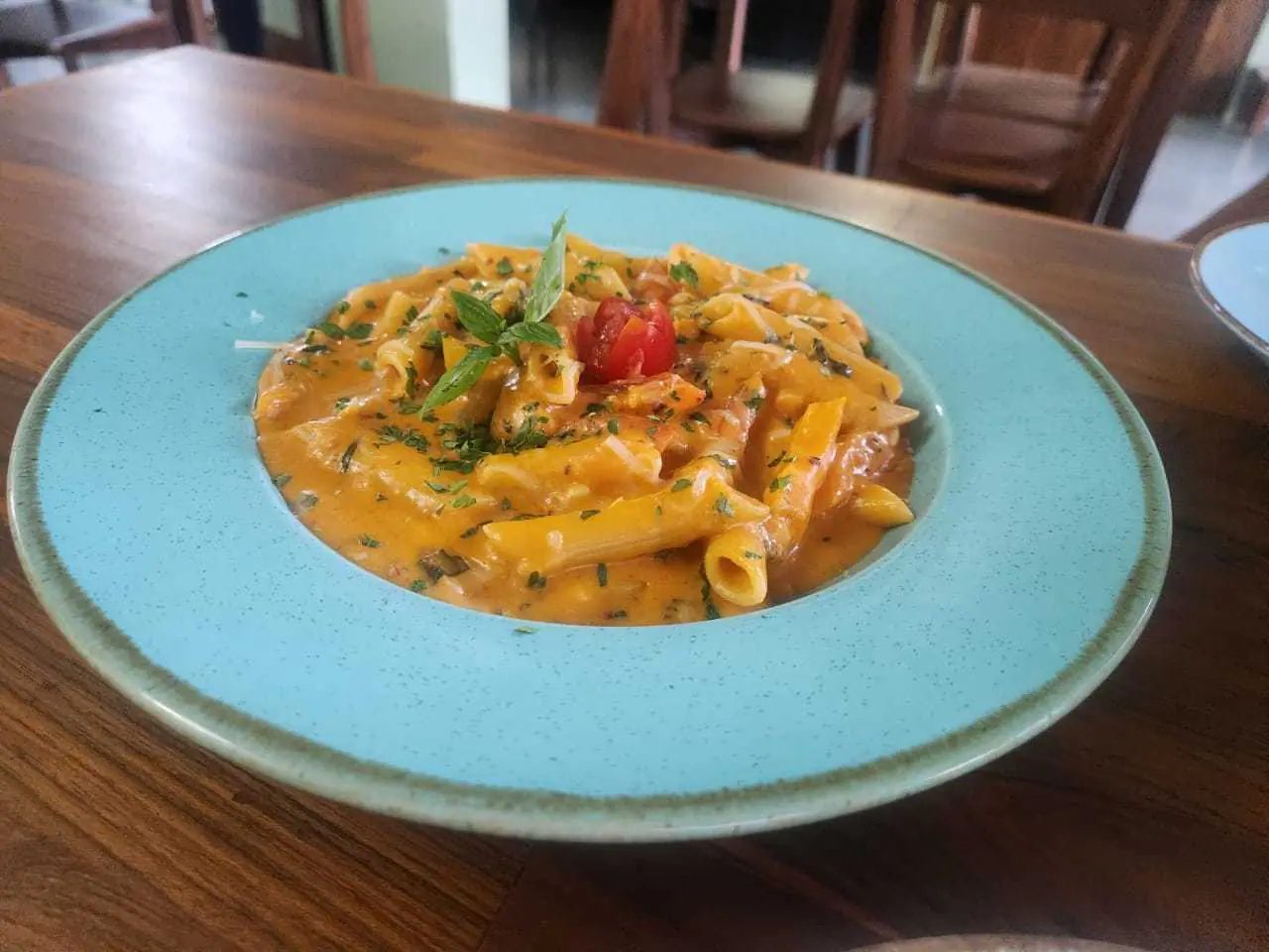 Penne in a creamy pink sauce with fresh herbs