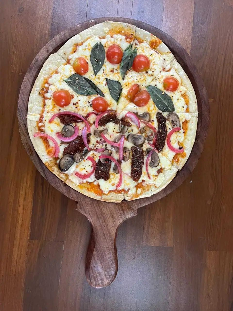 A classic margarita pizza with basil and cherry tomato