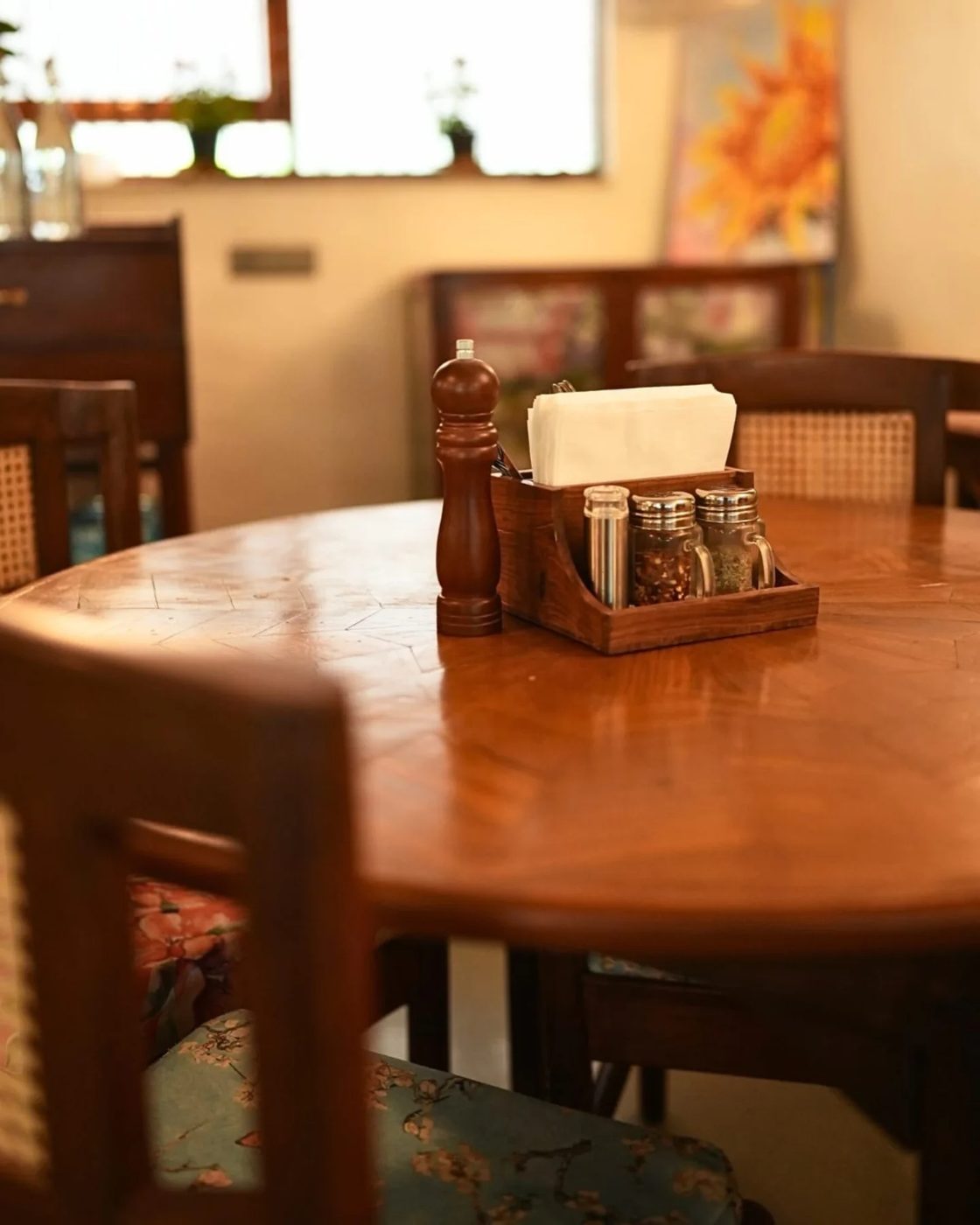 A small corner table with a pepper mill and cruet set