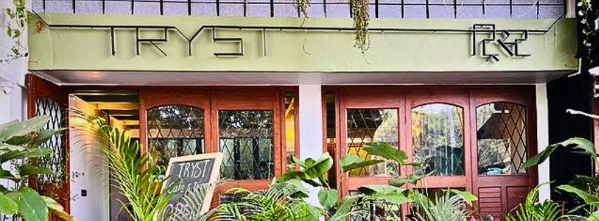 The TRYST storefront on FC Road, framed by plants and glass doors