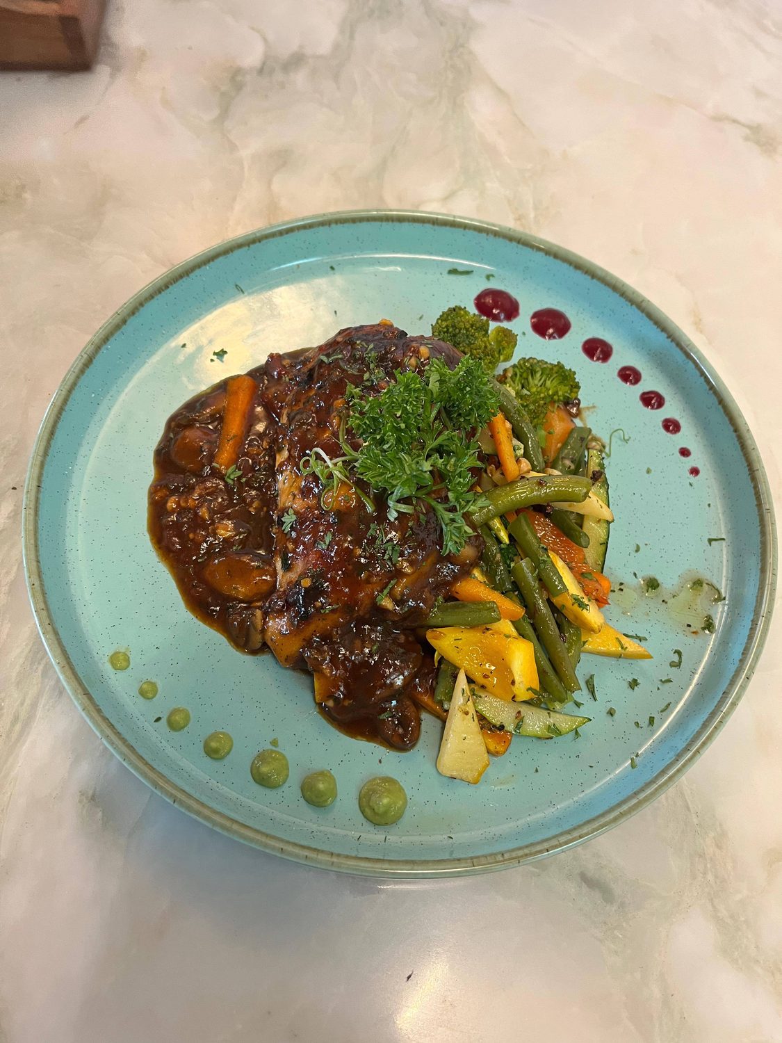 A vegetable steak with sautéed carrots, beans and a rich gravy