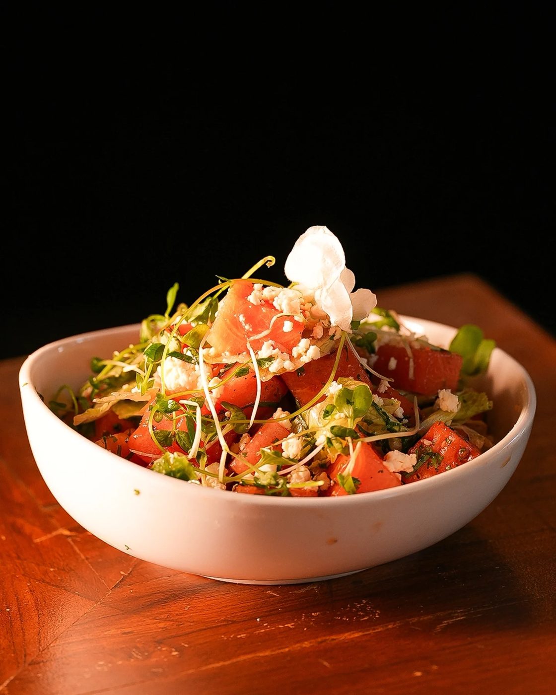 Watermelon basil feta salad topped with micro greens